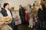 People take shelter in a cold storage locker in the back of the C & S Market in Eudora on Sept. 12, 2008 as tornado sirens sound in the county. From left are C & S employee Lucas Wright, Eudora; 16-month-old Cosette Kemnitz and her mother Olivia Kemnitz, Mission; Renee Brown, Eudora; and Jenna Johnston and Kristen Scott, both of Overland Park. Several travelers passing through Eudora on Kansas Highway 10 took shelter at the grocery, just off K-10 as a major storm passed through the area.