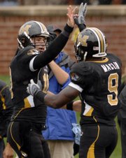 Missouri quarterback Chase Daniel, left, congratulates Jeremy Maclin after Maclin's 80-yard touchdown reception against Nevada on Saturday. The Tigers lead the country with a scoring average of 57.67 points per game.