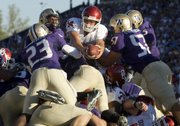 Oklahoma quarterback Sam Bradford reaches over the Washington defense to score a touchdown Saturday in Seattle. With a scoring average of 42.32 points per game, the Big 12 tops all major BCS conferences.