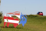 A metal buffalo painted like an American flag greets motorists as they pass Don and Terri Gibbs' buffalo ranch west of Baldwin. The pair had a taste of buffalo more than 20 years ago and now have a herd of 22 west of Baldwin on their 50-acre farm. The farm is on this year's Kaw Valley Farm Tour, Oct. 4-5.