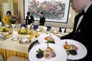 Chinese waiters and waitresses prepare a lunch for a high-level official event at the Diaoyutai State Guesthouse in Beijing in this Dec. 11, 2007, file photo. The nation's political elite has access to gourmet, all-organic delicacies while the rest of the populace face a food supply fraught with sometimes harmful items - cancer-causing fish, pesticide-laden vegetables and chemical-tainted milk products.