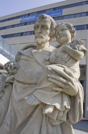 A statue of St. Joseph holding the infant Jesus stands outside of Creighton Medical Center in Omaha, Neb., where nine siblings were abandoned by their father Wednesday. Eleven children ranging in age from 1 to 17 were left at hospitals Wednesday under Nebraska's unique safe haven law, which allows caregivers to abandon not only infants but also teenagers without fear of prosecution.