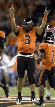Oregon State quarterback Lyle Moevao celebrates a 27-21 victory over Southern Cal. The Beavers beat the top-ranked Trojans on Thursday in Corvallis, Ore.