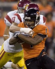 Oregon State running back Jacquizz Rodgers (1) is tackled from behind by USC defender Brian Cushing. Oregon State stunned USC, 27-21, on Thursday in Corvallis, Ore.