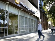 Arun Chatterjee waits for a branch of Washington Mutual to open Friday in downtown Sacramento, Calif. Washington Mutual, one of the nation's largest banks, was seized by the Federal Insurance Corp., Thursday, and then sold to JPMorgan Chase & Co.