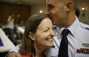 Tammy Ziesenis, left, welcomes her son, Sid Pastor III, home from his third tour of duty in Iraq on Saturday during a celebration at the Veterans of Foreign Wars Post 852 in Lawrence. The surprise party for Pastor, a senior airman in the U.S. Air Force, was also a reception and welcoming for his new wife, Nikki Pastor.