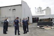 Lawrence & Douglas County Fire & Medical personnel wait for investigators at the site of an Oct. 5, 2008, fire in the former AB Coker Building, 1927 Moodie Road. The building housed a new off-site brewery and bottling facility for Free State Brewing Co.
