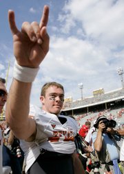 Texas quarterback Colt McCoy, in photo at left, celebrates after the Longhorns' 45-35 victory over OU Saturday in Dallas.