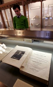 Yale University employee Geoffrey Little looks at an early edition of Noah Webster's Dictionary at the Sterling Memorial Library at Yale University in New Haven, Conn. Webster's 250th birthday will be observed this week.