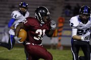 Lawrence High Lion Clifton Sims speeds past the Olathe Northwest Raven defense for a touchdown during a game at Haskell Stadium on Friday, Oct. 17, 2008.