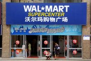 Customers leave a Wal-mart supercenter June 20 in Loudi, Hunan Province, China. Maoming, Wuhu and Loudi are Chinese cities so far in the boonies that the popular Lonely Planet travel guide doesn't even mention them, but retailers are seeking opportunities for growth there.