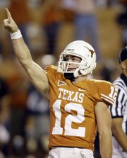 Texas quarterback Colt McCoy celebrates after rushing for a touchdown. Texas embarrassed Missouri, 56-31, on Saturday night in Austin, Texas.