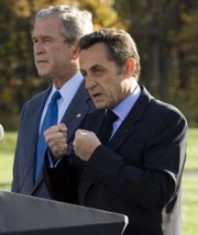 French President Nicolas Sarkozy, right, speaks about the world economy with President Bush on Saturday at Camp David, Md.