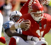 Kansas City Chiefs quarterback Damon Huard (11) is sacked by Tennessee Titans defensive tackle Albert Haynesworth.