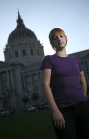 Prostitute Patricia West, 22, poses for a photograph Friday in front of City Hall in San Francisco. San Francisco would become the first major U.S. city to decriminalize prostitution if voters next month approve Proposition K, which forbids local authorities from investigating, arresting or prosecuting anyone for selling sex.