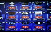 Stock prices are shown Friday at the Nasdaq MarketSite in Times Square, in New York. The stark message has grown louder and clearer this month as more investors fled the disintegrating stock market and corporate earnings reports delivered a procession of disheartening results, bleak forecasts and mass layoffs likely to exacerbate the economic misery.