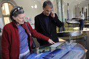 Lynne Kovach, left, of Chevy Chase, Md., looks at information about wind turbines with her son Charles Kovach, of Tampa, Fla., at the "Green Community" exhibit on its opening day Thursday at the National Building Museum in Washington, D.C. The exhibit will run for a full year through October 2009.