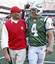 Kansas City Chiefs coach Herm Edwards, left, and New York Jets quarterback Brett Favre talk while walking off the field.