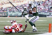 New York Jets wide receiver Laveranues Coles (87) makes a fourth-quarter reception for a touchdown around Kansas City Chiefs cornerback Dimitri Patterson. The Jets won, 28-24, Sunday in East Rutherford, N.J.