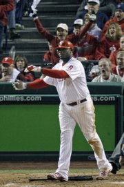 The Philadelphia Phillies' Ryan Howard (6) watches his two-run home run off Tampa Bay relief pitcher Trever Miller. Howard homered twice in the Phillies' 10-2 victory over the Rays on Sunday in Philadelphia. The Phillies took a 3-1 lead in the World Series.