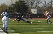 Baker senior wide receiver James Hensley (5) evades Missouri Valley defenders in Baker's 26-22 victory Saturday in Baldwin City.