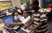 Hillcrest School sixth-graders, from left, Jay Xayasaeng, of Laos, Sebastian Joseph and Alex Mwithiga, of Kenya, work through transformational geometry Thursday at the school, 1045 Hilltop Drive. Many international students make up the student body.