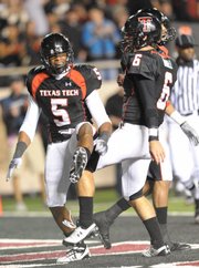 Texas Tech's Michael Crabtree and Graham Harrell celebrate after a touchdown against Oklahoma State. Harrell (40-for-50, 456 yards, 6 TD's) and Crabtree (eight catches, 89 yards, three TD's) had a field day against the Oklahoma State defense, and the Red Raiders dominated the Cowboys, 56-20, on Saturday in Lubbock, Texas.