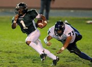 Free State quarterback Camren Torneden zips past Olathe Northwest senior defensive lineman Rick Haynes for a touchdown on Oct. 31, 2008, at Haskell Stadium. Torneden led the Firebirds to an appearance in the state title game last season and will return for his senior year.