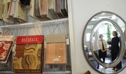 Elvira Angeletti,at right in the mirror, owner of Elvira Angeletti Interiors, 1015 W. Ninth St., and her associate, Julie Stewart, recommend budgeting well for upholstered furniture. If you cannot afford top-of-the-line items, they suggest shopping at estate sales and reclaiming well-made items.