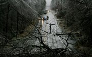 Traffic is redirected Friday in Derry, N.H., after a utility pole snapped because of an overnight ice storm. The ice storm knocked out power to more than a million homes and businesses in New England, New York and Pennsylvania.