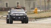 Brodie Charlton, 3, drives his Christmas gift, a new toy Ford truck, around his neighborhood Friday in the record-high warmth. Temperatures aren’t expected to climb out of the 40s and 50s today and next week, with rain in the forecast today.