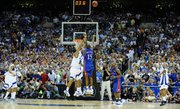 Kansas guard Mario Chalmers hoists a three-pointer over Memphis guard Derek Rose with seconds remaining in the second half of the national championship Monday, April 7, 2008, at the Alamodome in San Antonio.