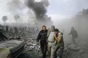 An injured Palestinian is helped from the rubble following an Israeli missile strike in Rafah, southern Gaza Strip, Saturday, Dec. 27, 2008. Israeli warplanes retaliating for rocket fire from Gaza pounded dozens of security compounds across the Hamas-ruled territory in unprecedented waves of air strikes Saturday, killing at least 155 and wounding more than 310 in the bloodiest day in Gaza in decades.