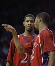 The Morris twins Markieff (left) and Marcus talk during a break in the action against Albany on Tuesday, Dec. 30, 2008 at Allen Fieldhouse.