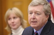 Gov. Kathleen Sebelius appointed Dan Biles, Shawnee, to the state Supreme Court on Wednesday. Amy McCart, Biles' wife, pictured at left in background, is assistant research professor at KU in the department of special education.