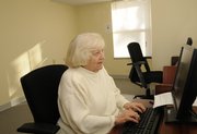 Alice Murphy, a resident of Clinton place Apartments, types an e-mail on one of two computers in the complex’s activity room.