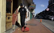 Calvin Jones, a supervisor for SDT Waste & Debris Services, sweeps up trash on Bourbon Street in the French Quarter of New Orleans Thursday, Jan. 8, 2009. Since Hurricane Katrina, the beer-soaked, urine-coated, puke-puddled French Quarter has been scrubbed clean. But if the city can't find a way out of its budget crisis, it may no longer be able to pay for the army of sanitation workers who pick up after the partying. (AP Photo/Alex Brandon)