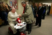 Dale Fowler, left, accepts words of kindness from Pat Mulvihill and other congregation members of the Williamstown Assembly of God, where a prayer vigil was held Sunday night for Fowler's son, Shawn Fowler. Shawn Fowler, 44, has been missing since Dec. 10, 2008.