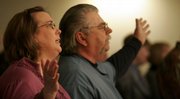 Becky Dunavin, left, and her husband, Rod, sing a hymn with other congregants of the Williamstown Assembly of God during a prayer vigil Sunday night for Shawn Fowler. Fowler, 44, has been missing since Dec. 10, 2008.