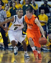 Oklahoma State guard Keiton Page, right, drives around Baylor's Curtis Jerrells late in the second half of an NCAA college basketball game on Saturday Jan. 17, 2009, in Waco, Texas. Baylor defeated Oklahoma State 98-92 in overtime.