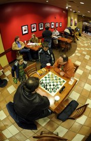 Lawrence includes a mix of national and local retailers. Maksin Smith, 6, and his brother Dmitri Smith, 10, watch James Fouche-Schack play chess at Borders, 700 N.H.