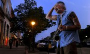 Dan Kozak, of Topeka, is a familiar sight in downtown Lawrence, performing music for passers-by at Seventh and Massachusetts streets.