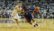 Kansas University’s Sherron Collins, right, drives against Kansas State’s Denis Clemente during their meeting in Manhattan. The former rivals have reunited at the Charlotte Bobcats’ summer league camp.