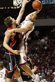 Oklahoma forward Blake Griffin, right, goes up for a basket against Texas Tech’s Michael Prince during OU’s victory on Saturday in Norman, Okla. The Sooners are well on their way to the NCAA Tournament, but the Red Raiders don’t have much of a shot.