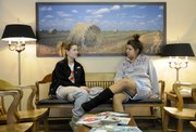 From left, KU freshmen Jen O'Hare and Abby Drogosz, both from Chicago, wait to see a doctor in the lobby of First Med and Walk-In Center, 2323 Ridge Court on Friday. Walk-in clinics are popping up across the nation to provide immediate care for people. Walk-In Center, 2323 Ridge Court, was one of the first walk-in clinics in Lawrence.