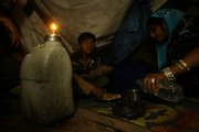 “Slumdog Millionaire” child actor Azharuddin Mohammed Ismail is served his dinner Thursday by his mother, Shamim Begum, right, in his home in a slum in Bandra, suburban Mumbai, India.