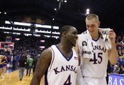 Kansas teammates Sherron Collins, front, and Cole Aldrich are all smiles leaving the court following the Jayhawks' win over Missouri Sunday, March 1, 2009 at Allen Fieldhouse.