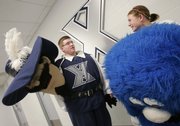 Xavier mascot Arick Stall, left, wearing the costume of D’Artagnan, talks with mascot Abby Strietmann, wearing the costume of the Blue Blob, prior to the game between Xavier and Dayton in Cincinnati.