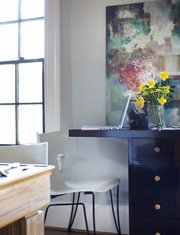 A 30-inch-tall console table can double as a temporary spot to check e-mail in the dining area, as shown in this room designed by Brian Patrick Flynn.