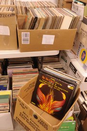 Leslie O'Neil, coordinator of Friends of the Lawrence Public Library, looks down stacks of books that are being processed for the annual book sale.